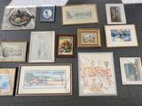 a lot of framed art on the floor of this room