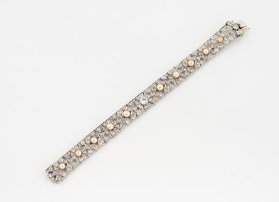 a diamond and gold bracelet on a white background