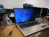 a laptop computer sitting on top of a wooden table