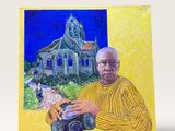 tableau représentant un homme tenant un appareil photo devant une église