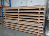 a stack of pallets in a warehouse with pallets on the floor