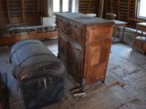 a room that has a wooden cabinet and a metal barrel in it