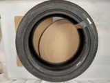 a close up of a tire on a cardboard box on a bed