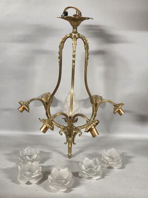 an image of a brass chandelier with four lights