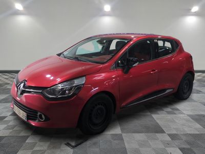 a red car parked in a garage with a checkered floor
