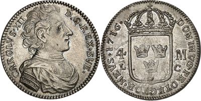 a silver coin with a crown on top of it