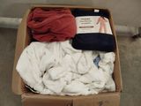 a box of clothes that is sitting on the floor