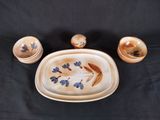 a picture of a set of dishes and salt and pepper shakers