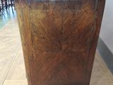 a wooden cabinet with a marble top in a room