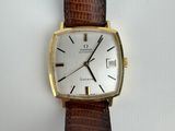 a close up of a watch on a white surface