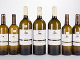 six bouteilles de vin blanc sont alignées