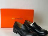 a pair of black loafers with a box on the side