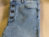 a close up of a pair of jeans hanging on a hanger