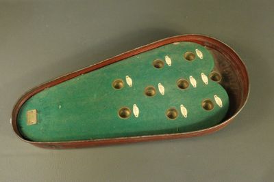a green case with holes in it on a table