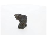 a close up of a statue of a cat on a white surface