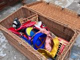a wicker basket filled with various items on the floor