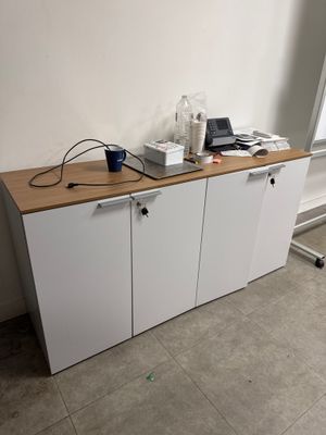 a white cabinet with a laptop on top of it