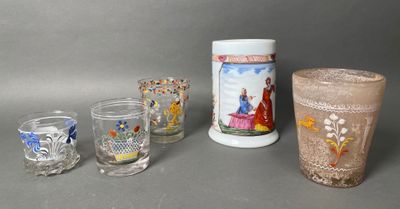 four glasses and a vase sitting on a table