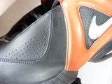 a close up of a pair of black and orange shoes