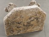 a stone sculpture of a dog ' s paw resting on it ' s back