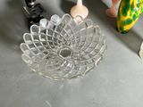 a glass bowl with a flower design on it next to a pair of scissors and a pair of scissors