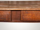 a wooden table with two drawers on top of it
