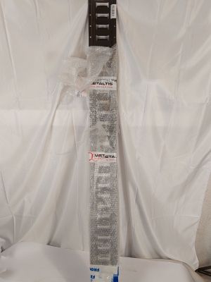 a picture of a television remote control sitting on top of a white sheet