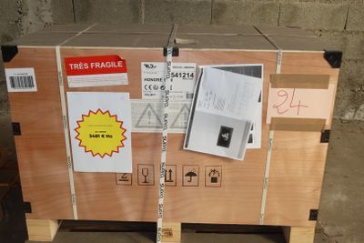 a wooden box with a sign on it sitting on a pallet