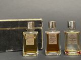 three bottles of perfume sitting next to each other on a table
