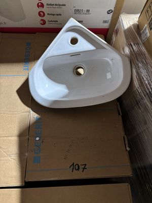 a white sink sitting on top of a cardboard box in a room