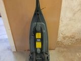 a vacuum that is sitting on the floor in the room