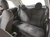 the back seats of a car with a black leather seat cover