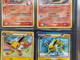 several pokemon cards are on display in a display case