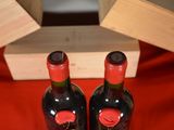 two bottles of wine sitting next to each other on a table