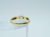 a gold ring with a diamond in it sitting on a glass