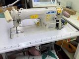 a sewing machine that is on a table in a room
