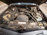 a car engine with its hood open in a garage
