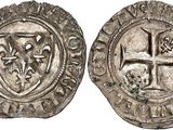 a silver coin with a cross on the front and a shield on the back