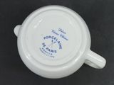 a close up of a white coffee cup with blue writing on it