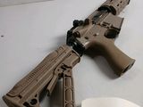 a close up of a rifle on a table with a tag