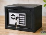a small black safe box with a key in it