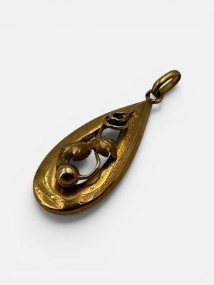 an image of a gold pendant on a white background