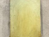 an antique brass plaque mounted on the wall of a building