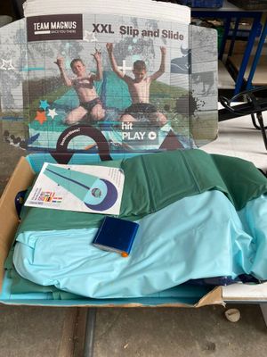 a cardboard box that has a skateboard and a book in it