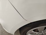 a close up of a car ' s front tire with a sticker on it
