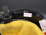 a close up of a yellow hat with a tag on it