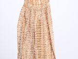 an image of a dress hanging on a hanger on a white wall