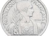 a close up of a coin on a white background with a picture of a woman