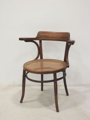an image of a wooden chair with a woven seat and backrest