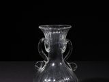 a glass vase that is sitting on a table